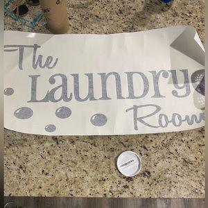 Stick on laundry room decor. Step up your area with this black wall decor.